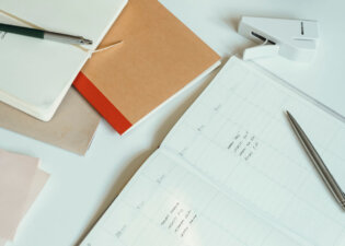 Image of Office Desk with Papers, Notebooks and Books