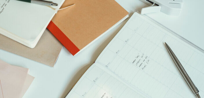 Image of Office Desk with Papers, Notebooks and Books